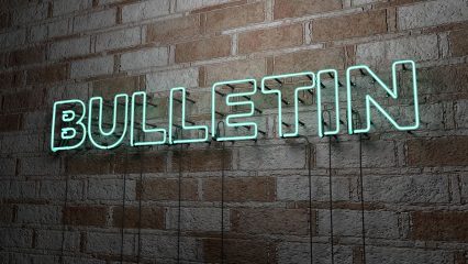 Bulletin in neon on brick wall