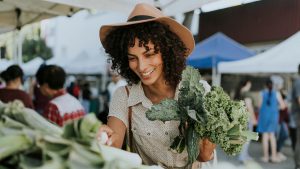Woman buying kale at a farmers market