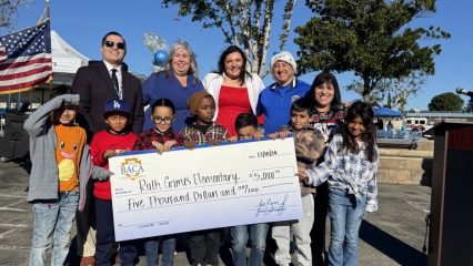 Supervisor Baca, Jr with Superintendent Miranda, Principal and Vice Principal of Ruth Grimes Elementary School, and students holding a $5,000 check from Supervisor Baca, Jr.