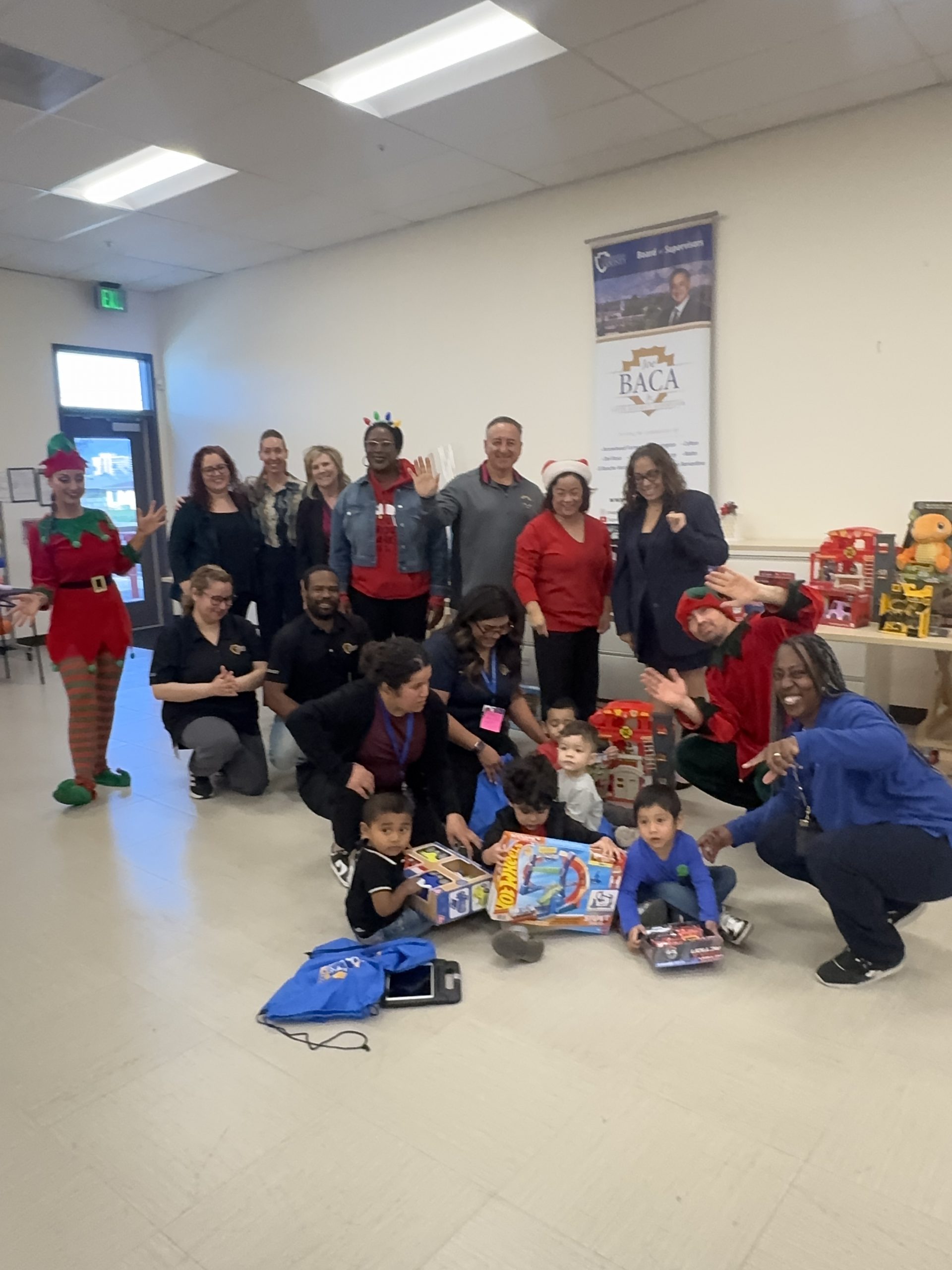 Supervisor Joe Baca, Jr. with Diane Higuchi of DAO Group, Arlene Molina of Preschool Services, and Mill Street Representatives at Pre-school Toy Giveaway.