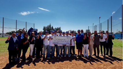 Supervisor Joe Baca, Jr. presenting a $300,000 check to San Bernardino Valley College Representatives and Baseball Team