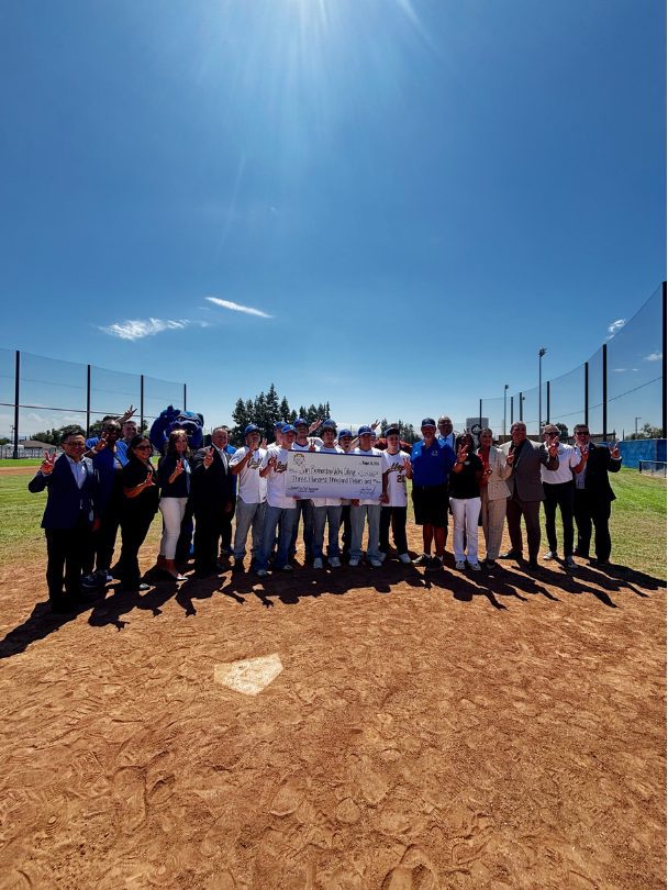 Supervisor Joe Baca, Jr. presenting a $300,000 check to San Bernardino Valley College Representatives and Baseball Team