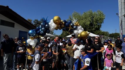 Supervisor Joe Baca, Jr. Fifth District Commissioners, City of Rialto Council Members, and representatives of North Rialto Little League cutting the ribbon for the Birdsall Park Snack Bar